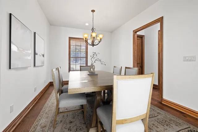 a view of a livingroom with wooden floor and a fireplace