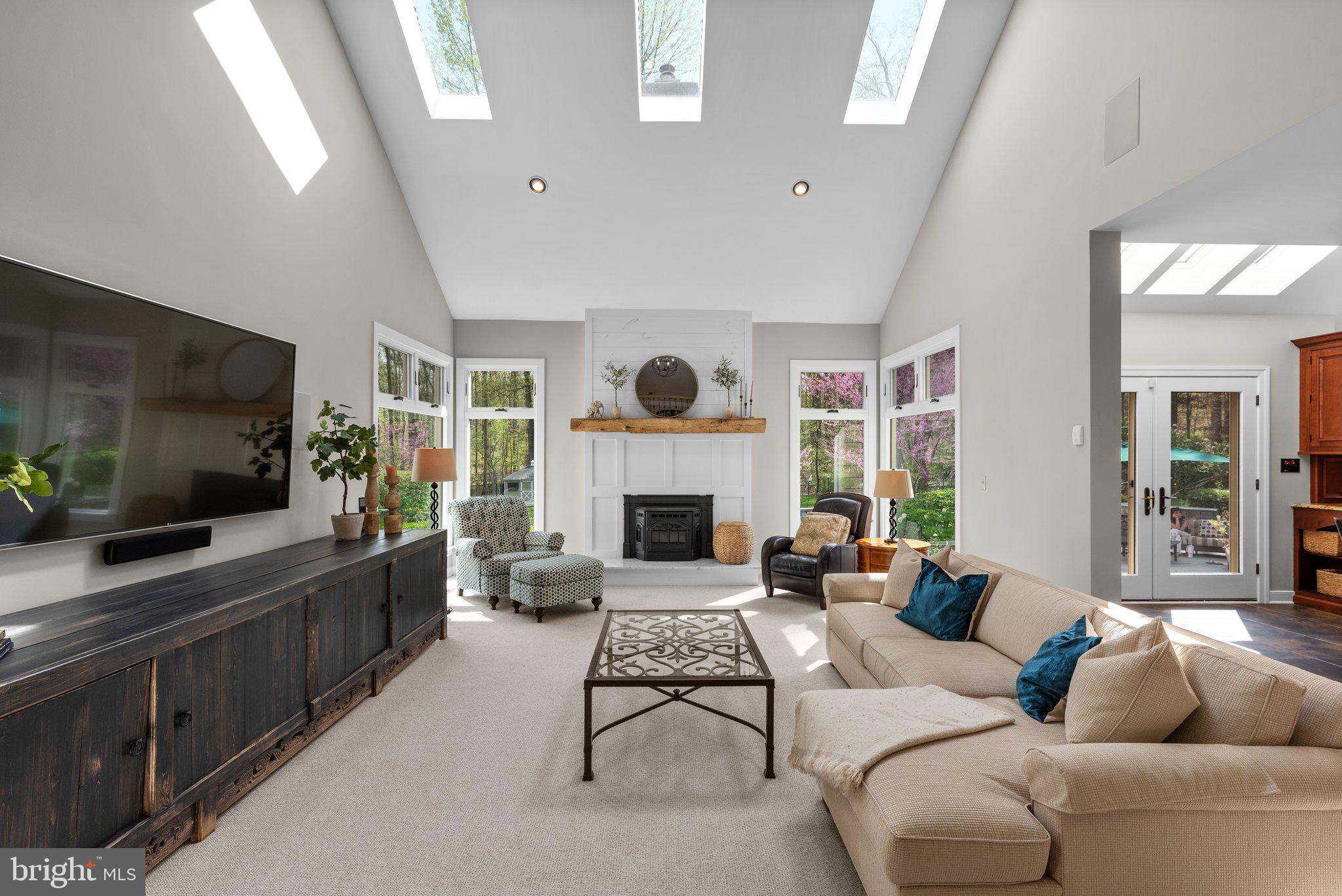 13791 Lakeside Drive Clarksville, MD 21029 - Photo 15 of 90 a living room with furniture a flat screen tv and a fireplace