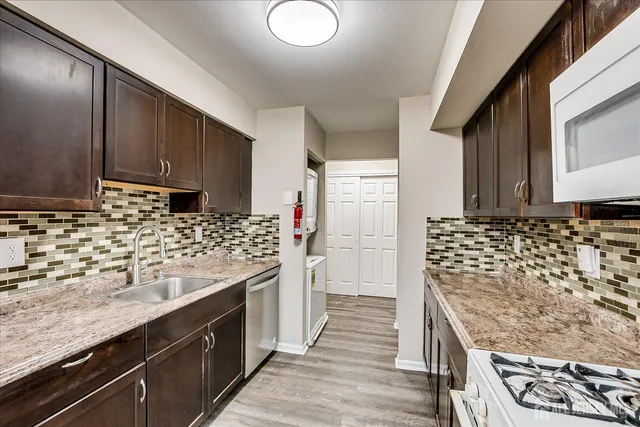 a kitchen with sink cabinets and stove
