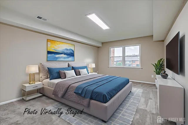 a bedroom with bed tv and window