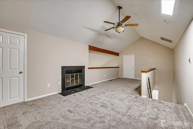a view of a livingroom with a ceiling fan and window