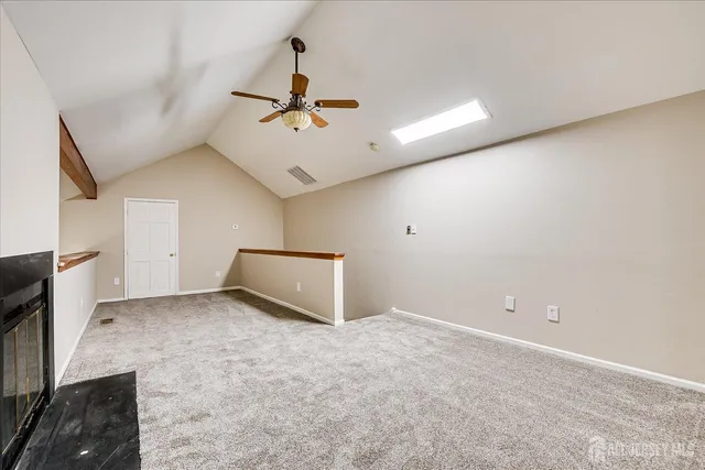 a view of a livingroom with a ceiling fan and window