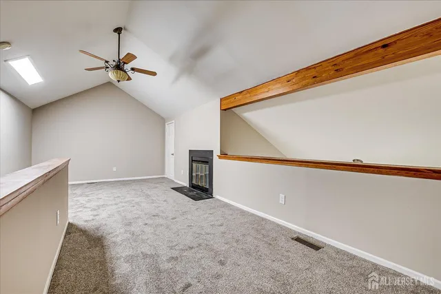 a view of a hallway with a ceiling fan