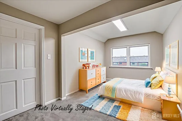 a bedroom with a bed and large windows