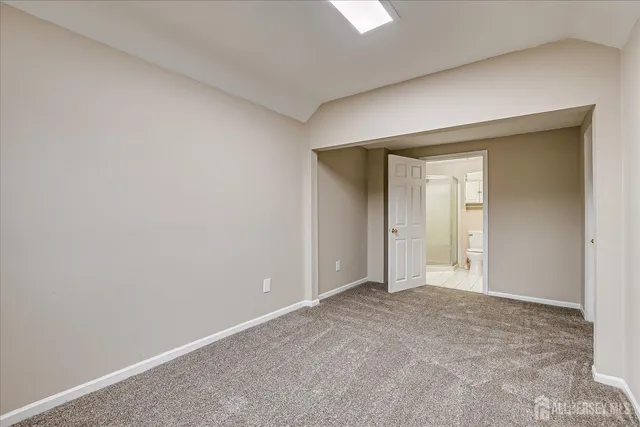 a view of an empty room and closet area