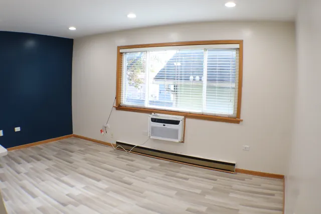 a kitchen with stainless steel appliances granite countertop a refrigerator a sink a stove and a refrigerator