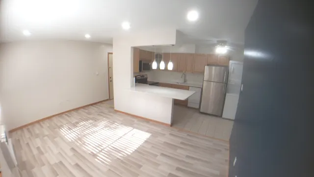 a kitchen with a refrigerator and a sink