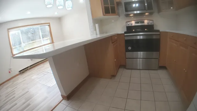 an empty room with wooden floor and closet