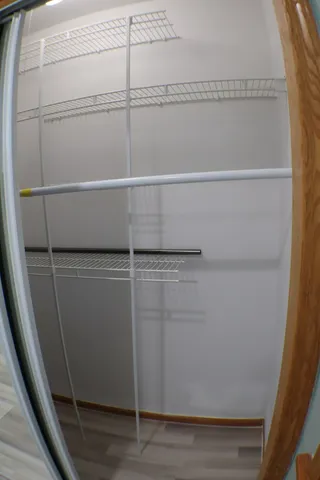 a view of a room with wooden floor