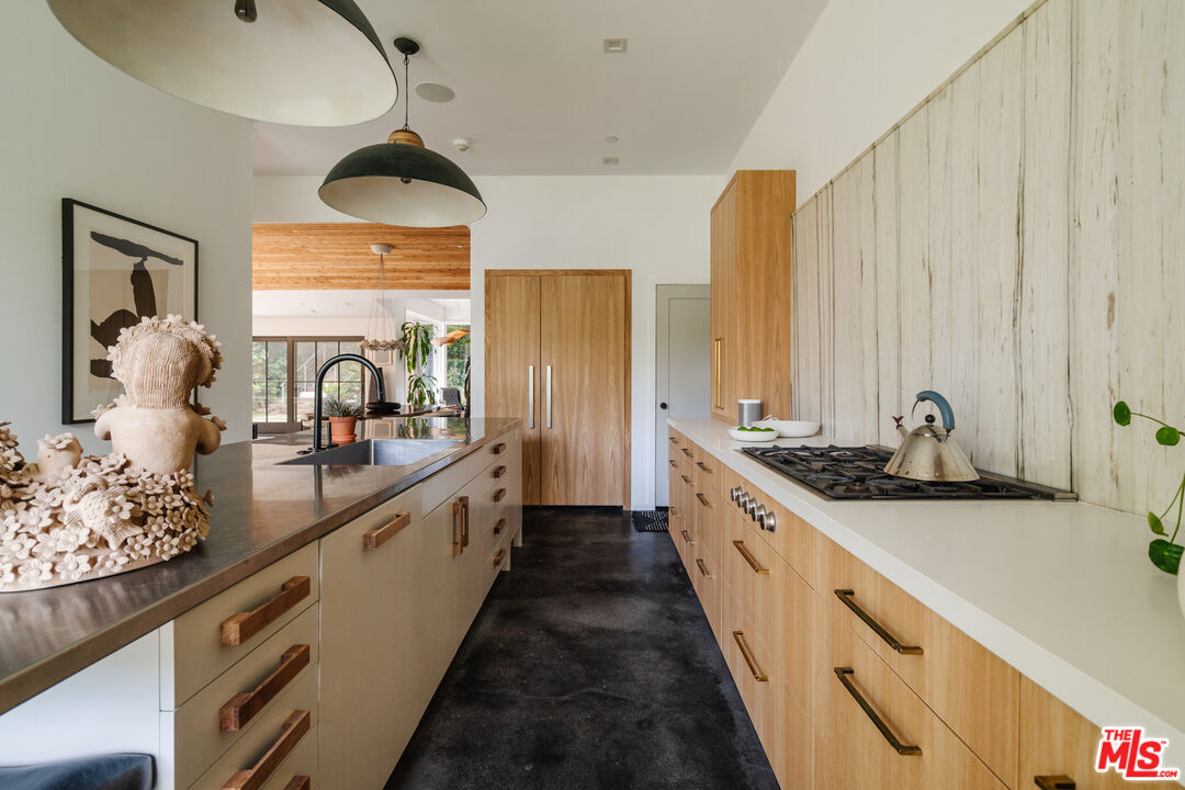 461 West Rustic Road Santa Monica, CA 90402 - Photo 4 of 7 a large kitchen with a large window and stainless steel appliances