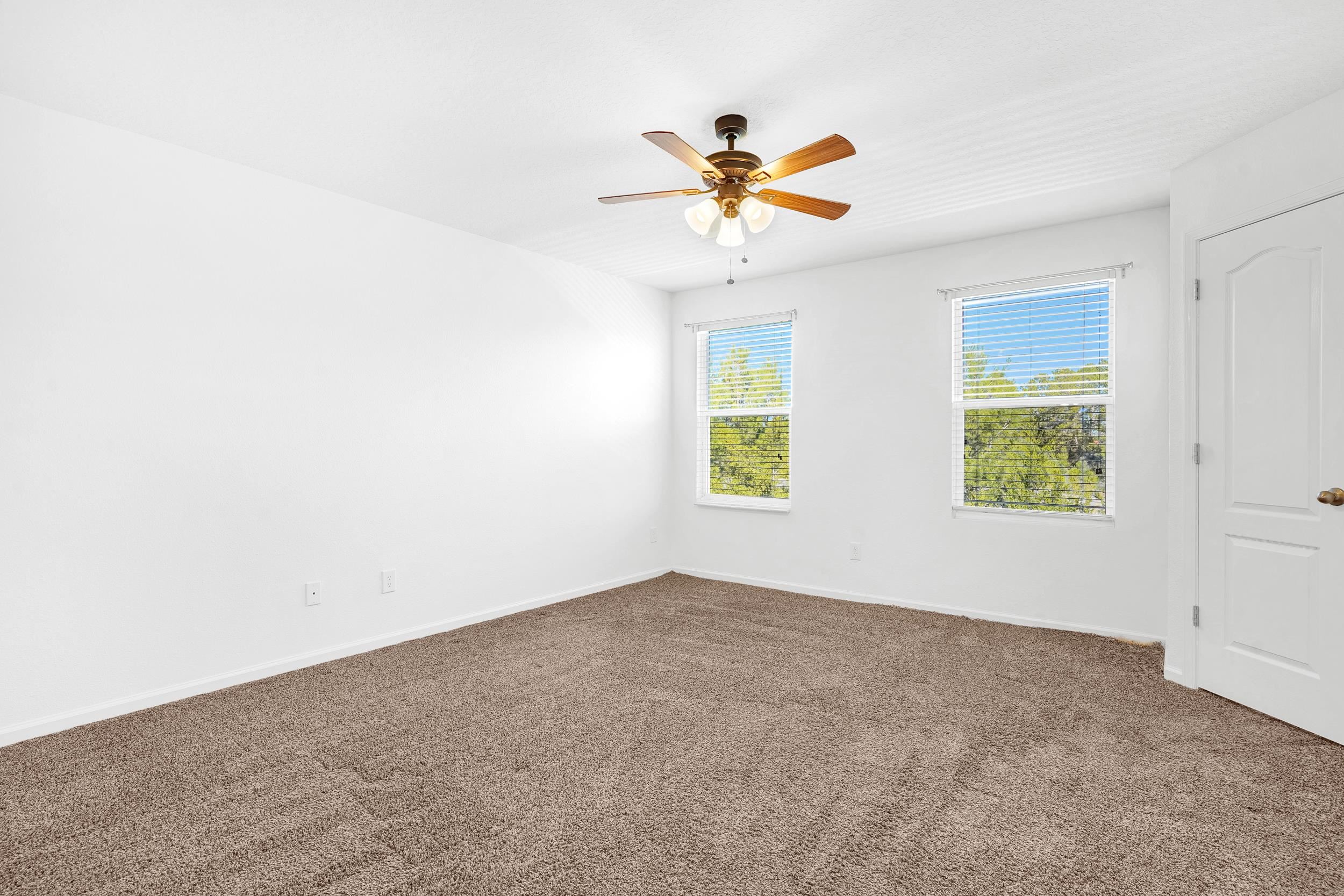 187 Whitland Way St. Augustine, FL 32086 - Photo 11 of 30 an empty room with windows and fan