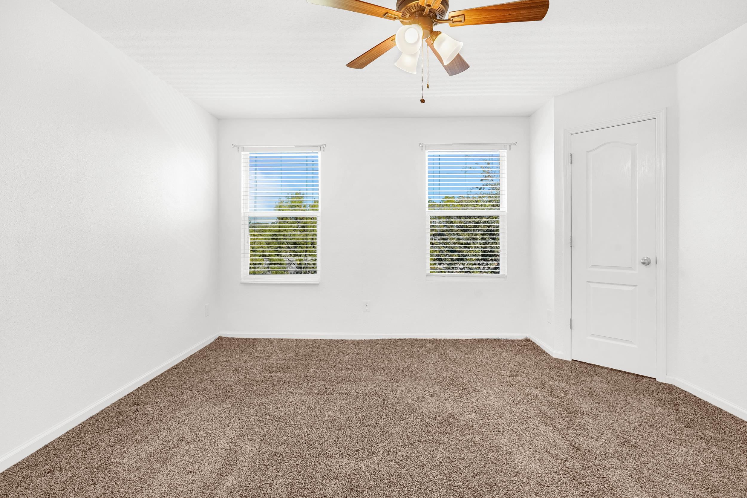 187 Whitland Way St. Augustine, FL 32086 - Photo 12 of 30 an empty room with a window and a ceiling fan