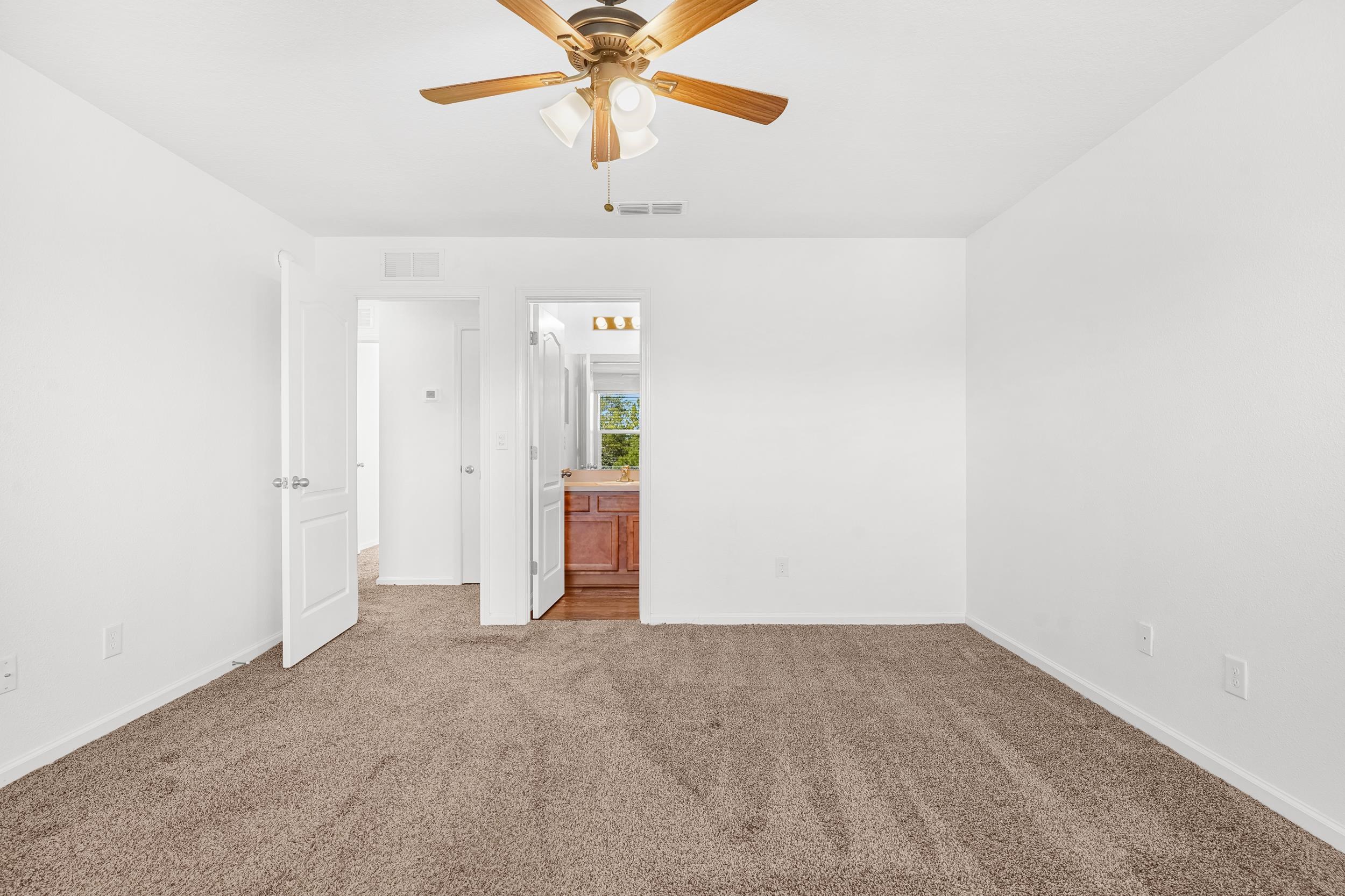 187 Whitland Way St. Augustine, FL 32086 - Photo 13 of 30 an empty room with closet and a chandelier fan