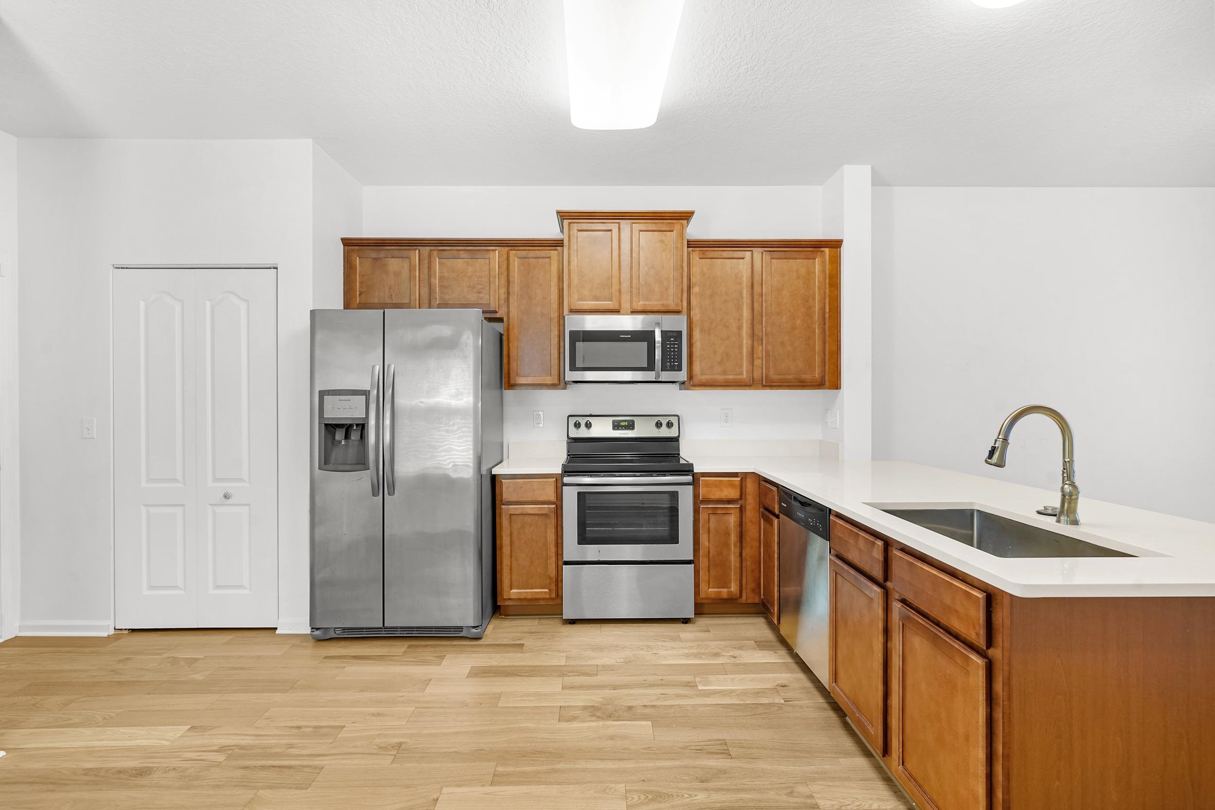 187 Whitland Way St. Augustine, FL 32086 - Photo 3 of 30 a kitchen with stainless steel appliances granite countertop a refrigerator stove and sink