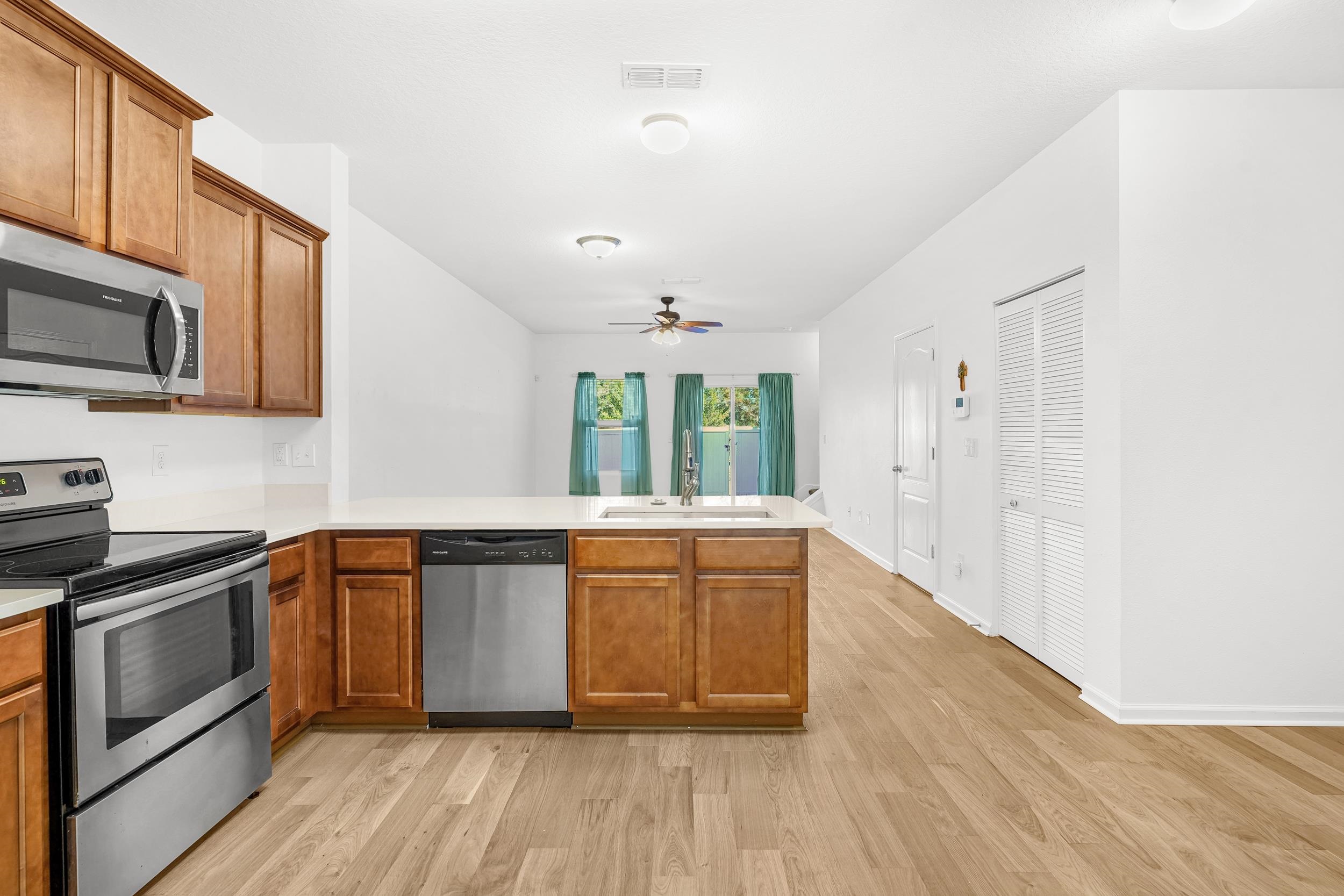 187 Whitland Way St. Augustine, FL 32086 - Photo 4 of 30 a kitchen with stainless steel appliances granite countertop a stove a sink and a refrigerator