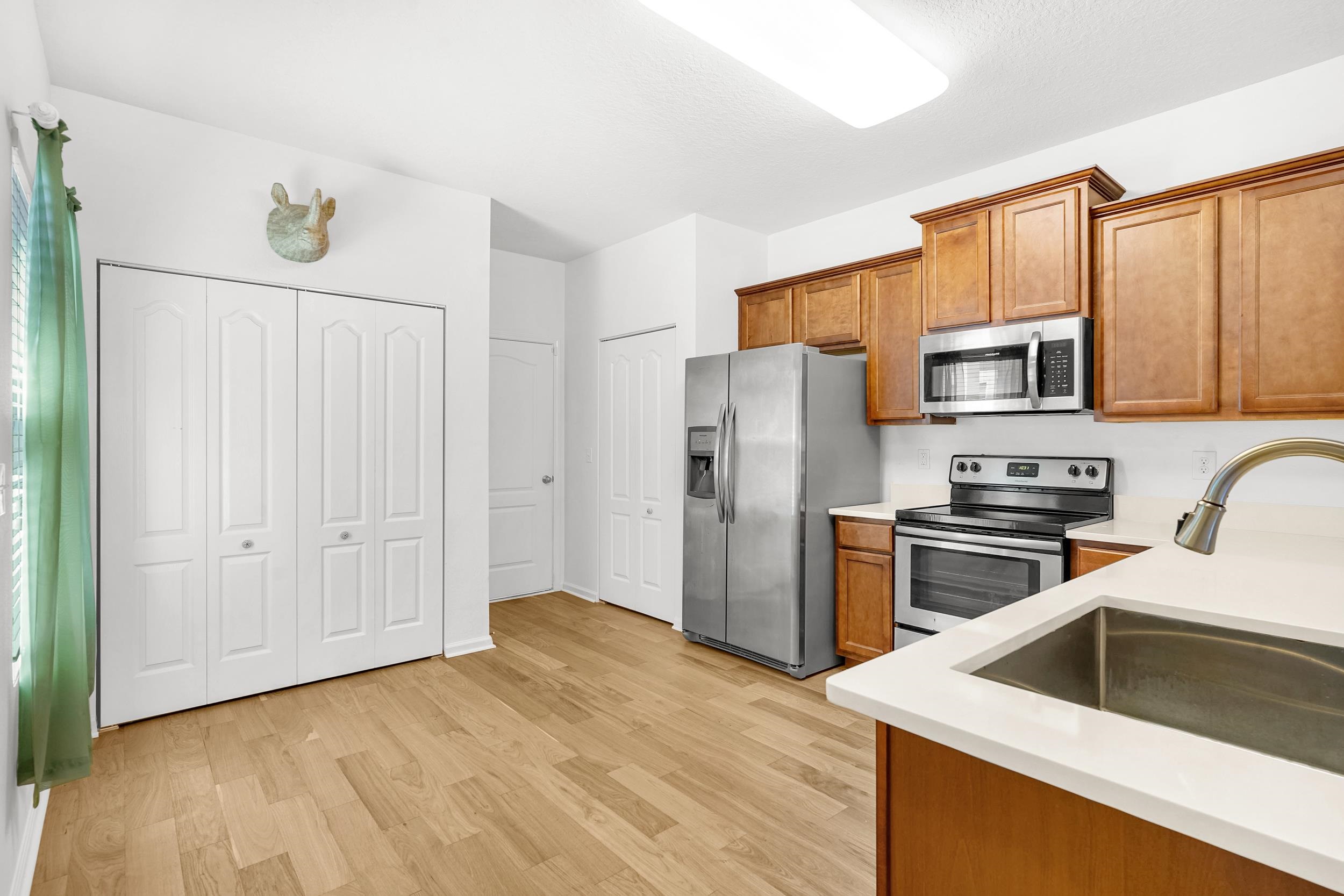 187 Whitland Way St. Augustine, FL 32086 - Photo 5 of 30 a kitchen with granite countertop a refrigerator stove and microwave