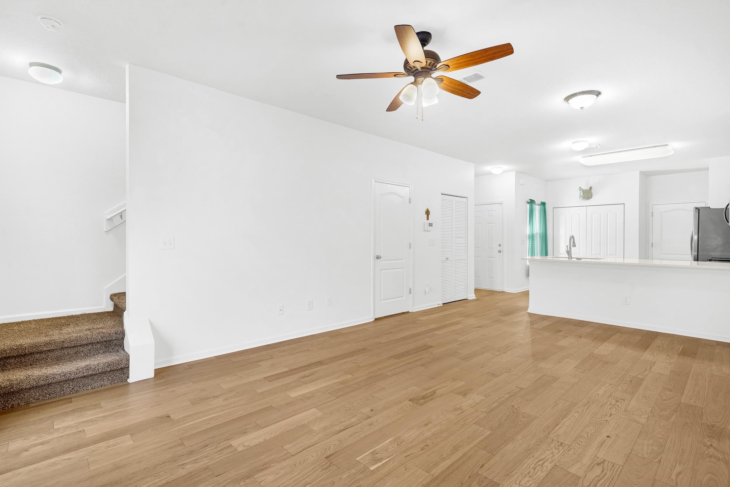 187 Whitland Way St. Augustine, FL 32086 - Photo 8 of 30 a view of empty room with wooden floor and ceiling fan
