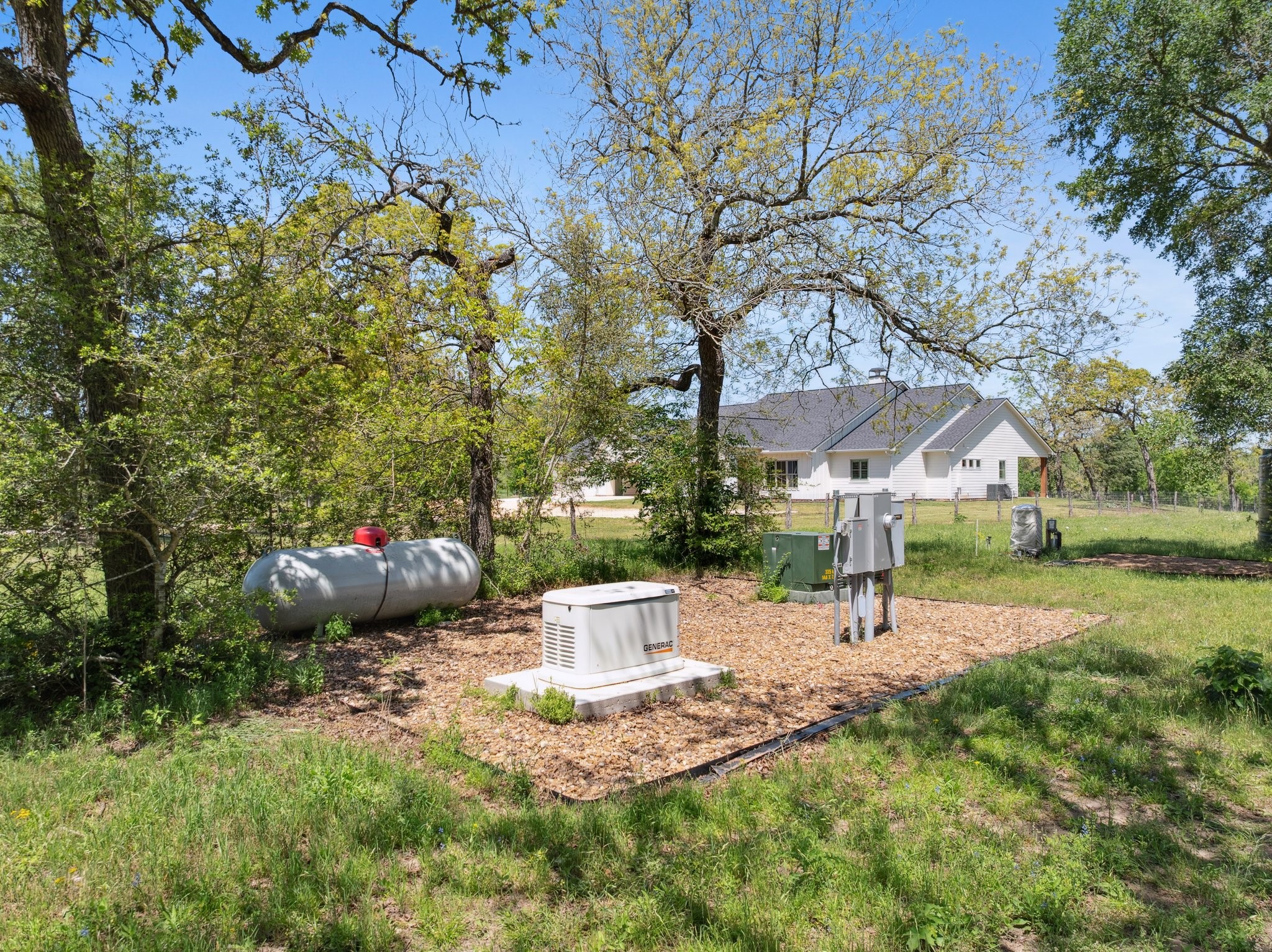 4052 Kuykendall Road Bellville, TX 77418 - Photo 32 of 40 This property features a reliable 500-gallon propane tank, ensuring the generator is always ready to provide power, offering peace of mind and energy independence.