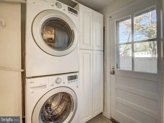 a view of a hallway with washer and dryer