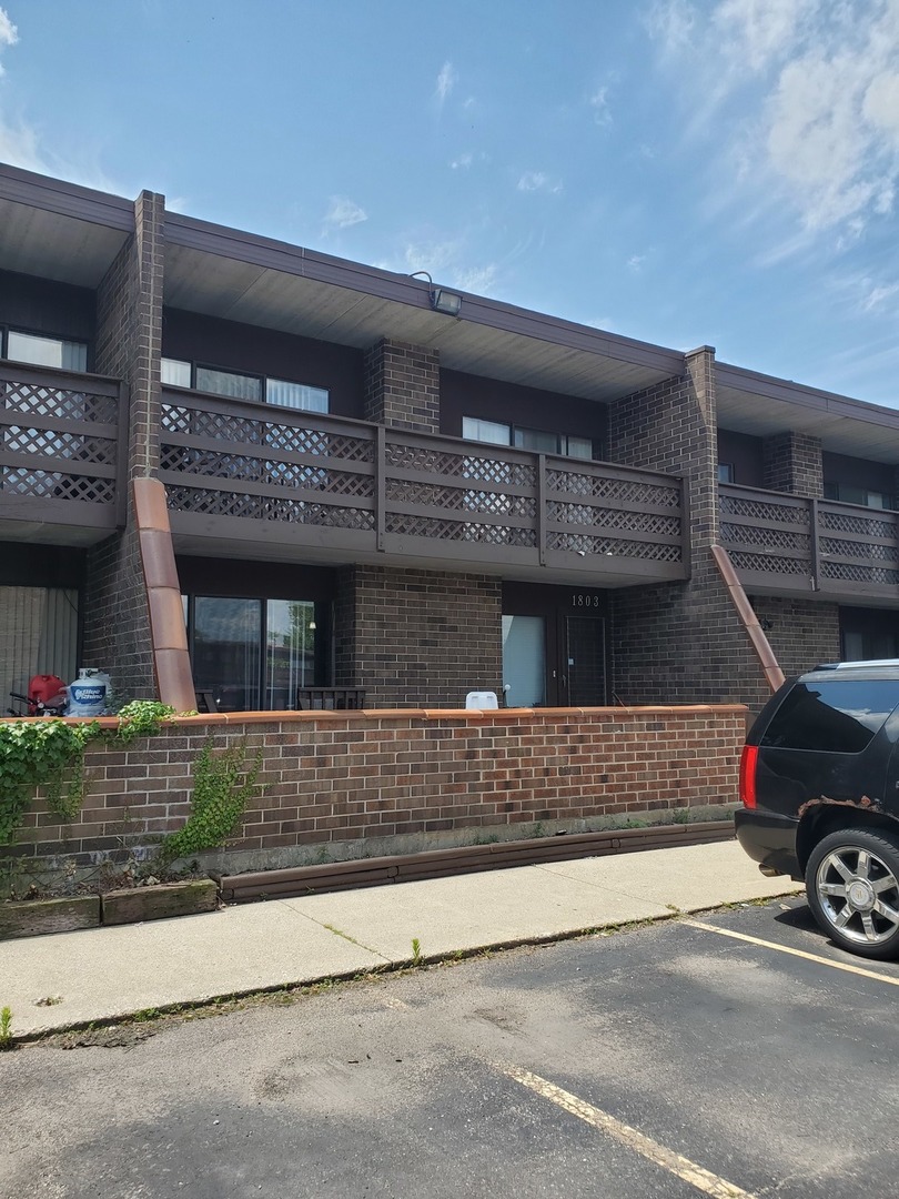 1803 Kenneth Circle Elgin, IL 60120 - Photo 2 of 4 a view of a car park in front of a building