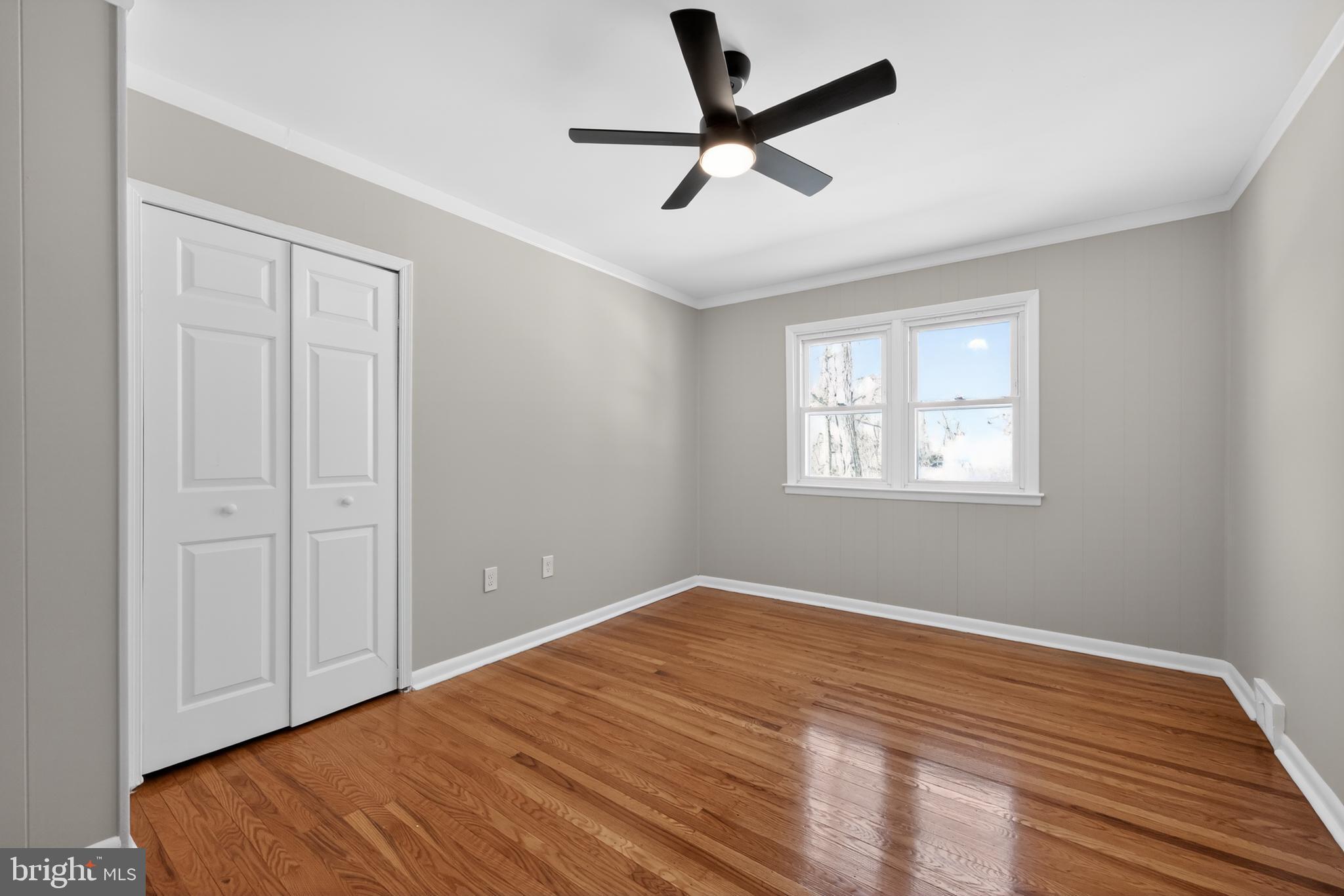 516 Beatty Road Springfield, PA 19064 - Photo 25 of 36 a view of a room with wooden floor and a ceiling fan