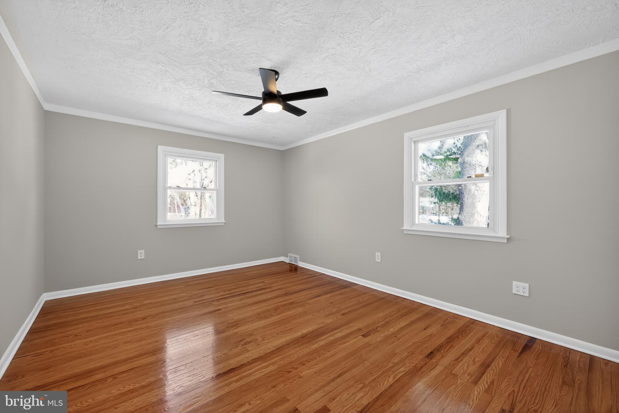 516 Beatty Road Springfield, PA 19064 - Photo 27 of 36 a view of empty room with wooden floor and fan