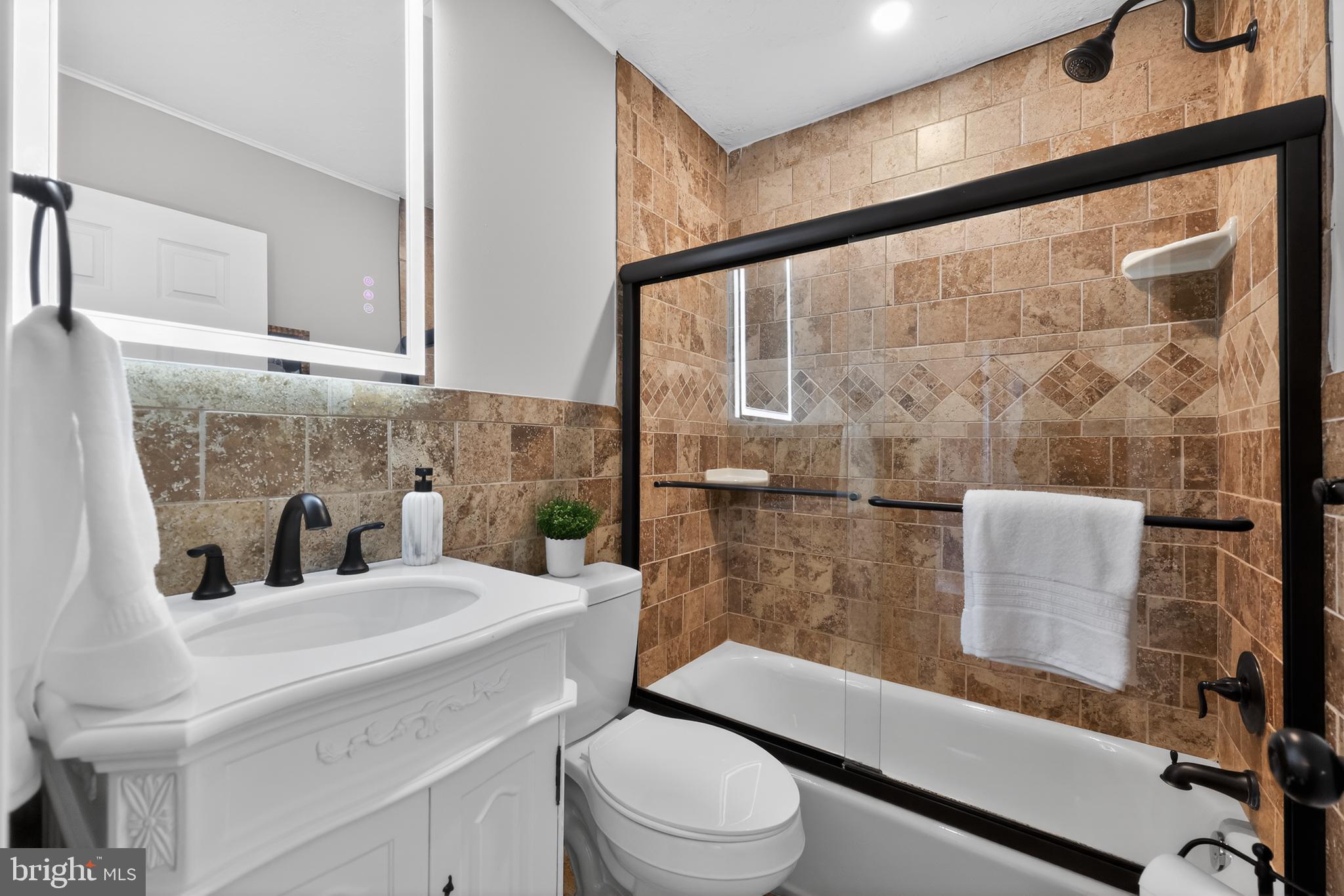 516 Beatty Road Springfield, PA 19064 - Photo 28 of 36 a bathroom with a sink a toilet and shower