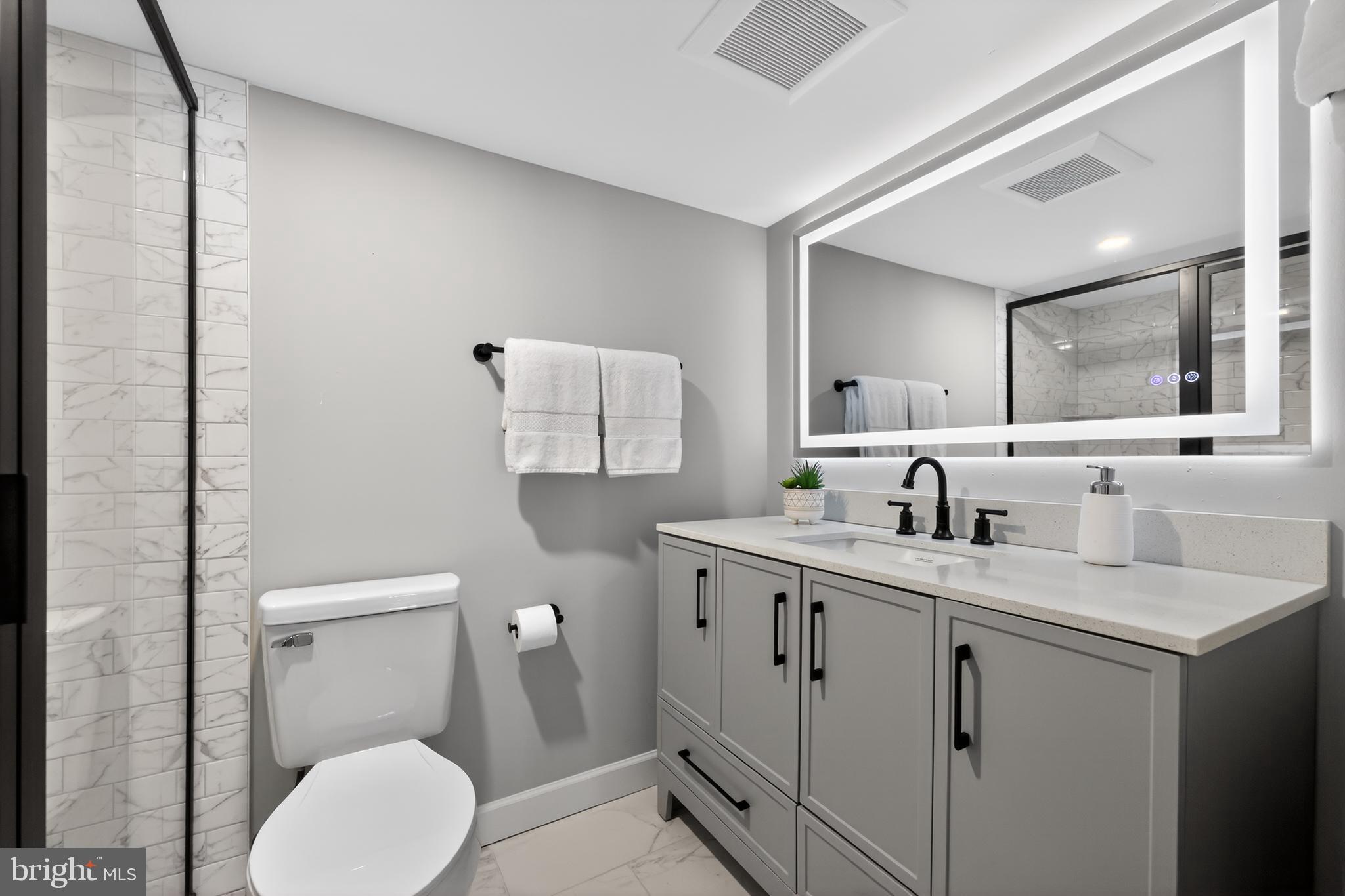 516 Beatty Road Springfield, PA 19064 - Photo 33 of 36 a bathroom with a toilet sink and mirror