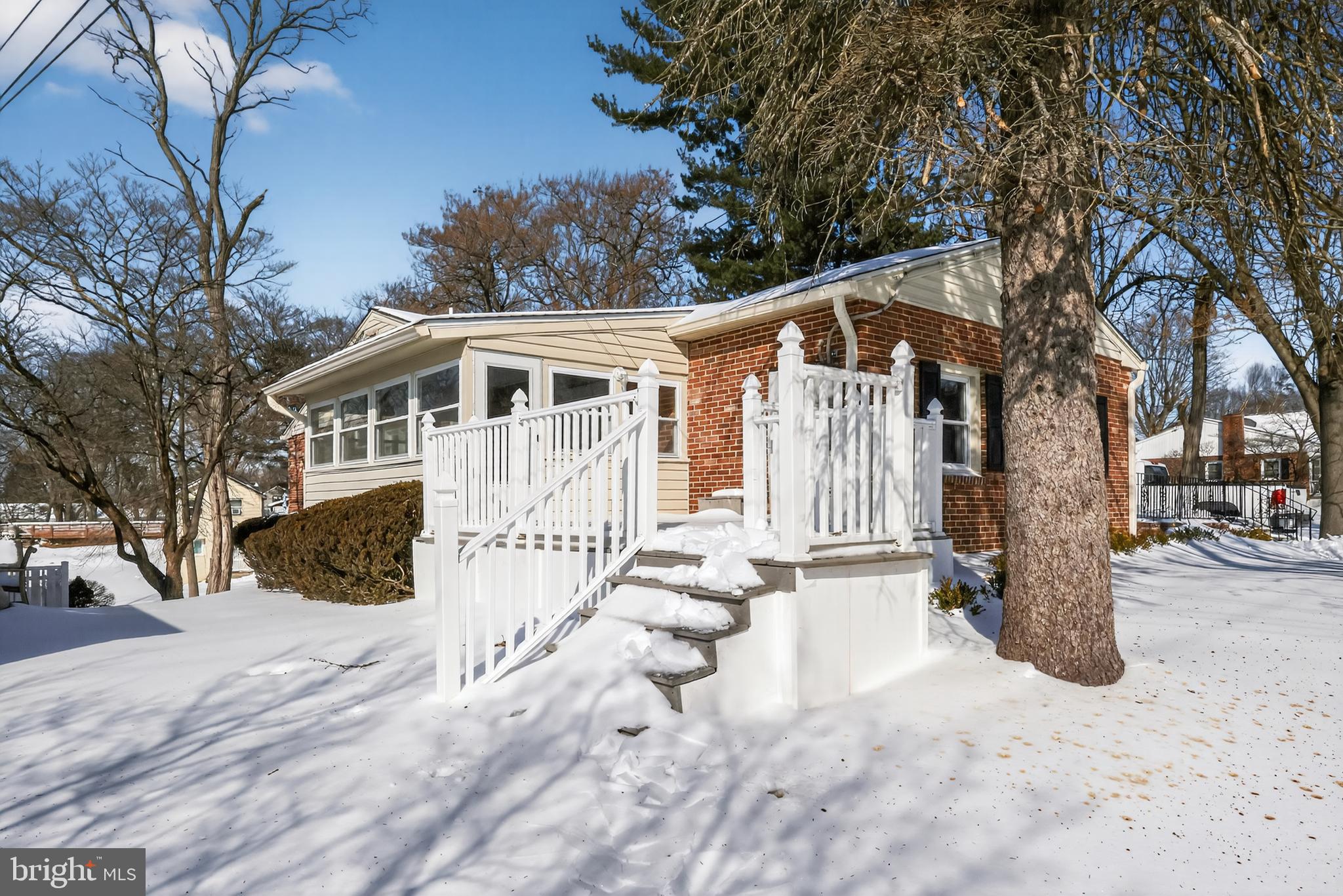 516 Beatty Road Springfield, PA 19064 - Photo 34 of 36 a front view of a house with a yard covered with snow