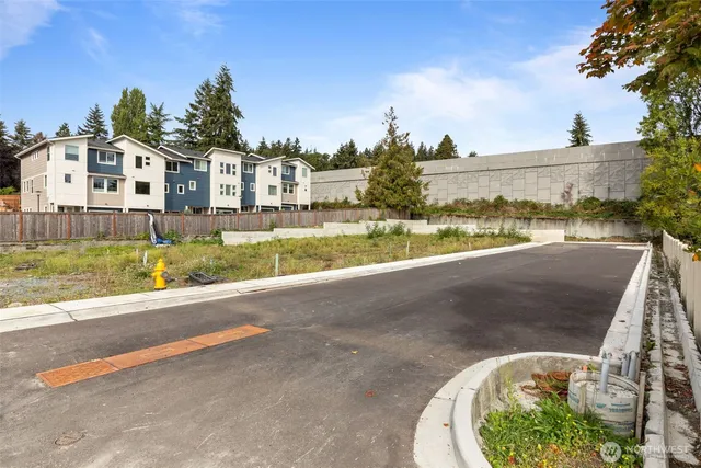 a view of a house with a yard and lake view
