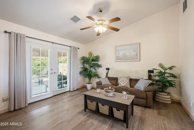 a view of a patio with table and chairs potted plants with wooden floor