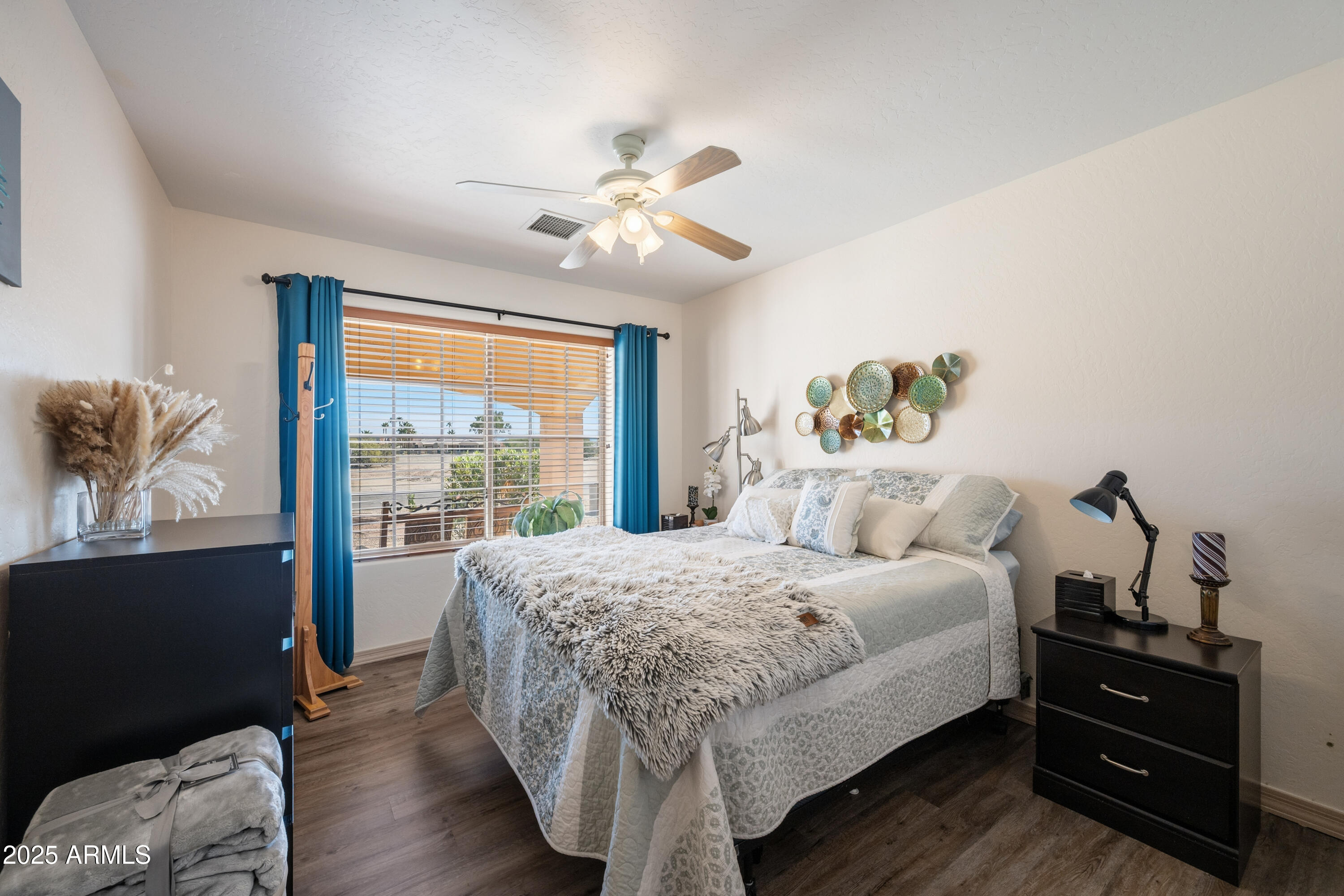 14844 South Brook Hollow Road Arizona City, AZ 85123 - Photo 14 of 35 a bedroom with a bed and wooden floor