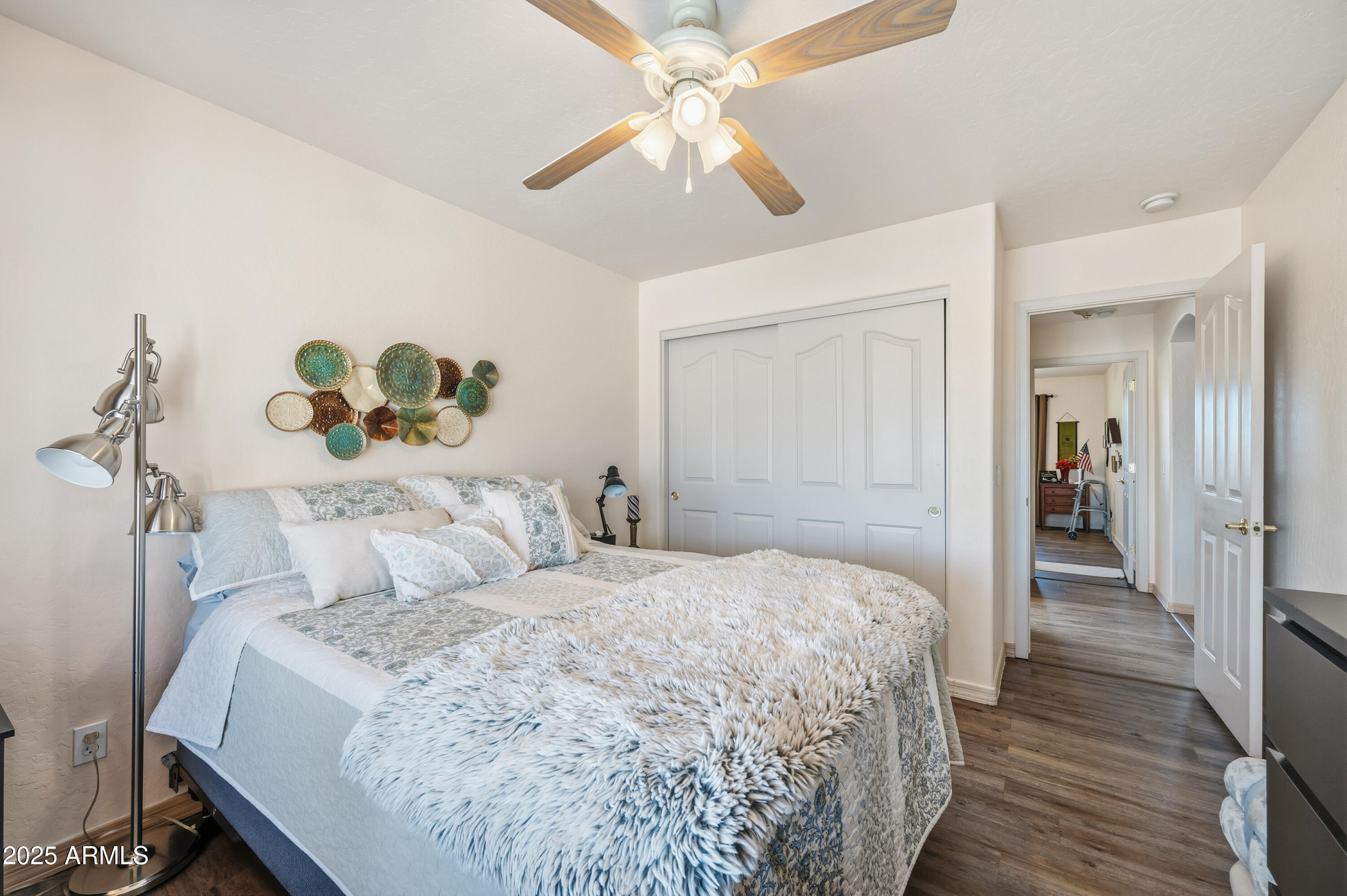 14844 South Brook Hollow Road Arizona City, AZ 85123 - Photo 15 of 35 a bedroom with a bed and a chandelier