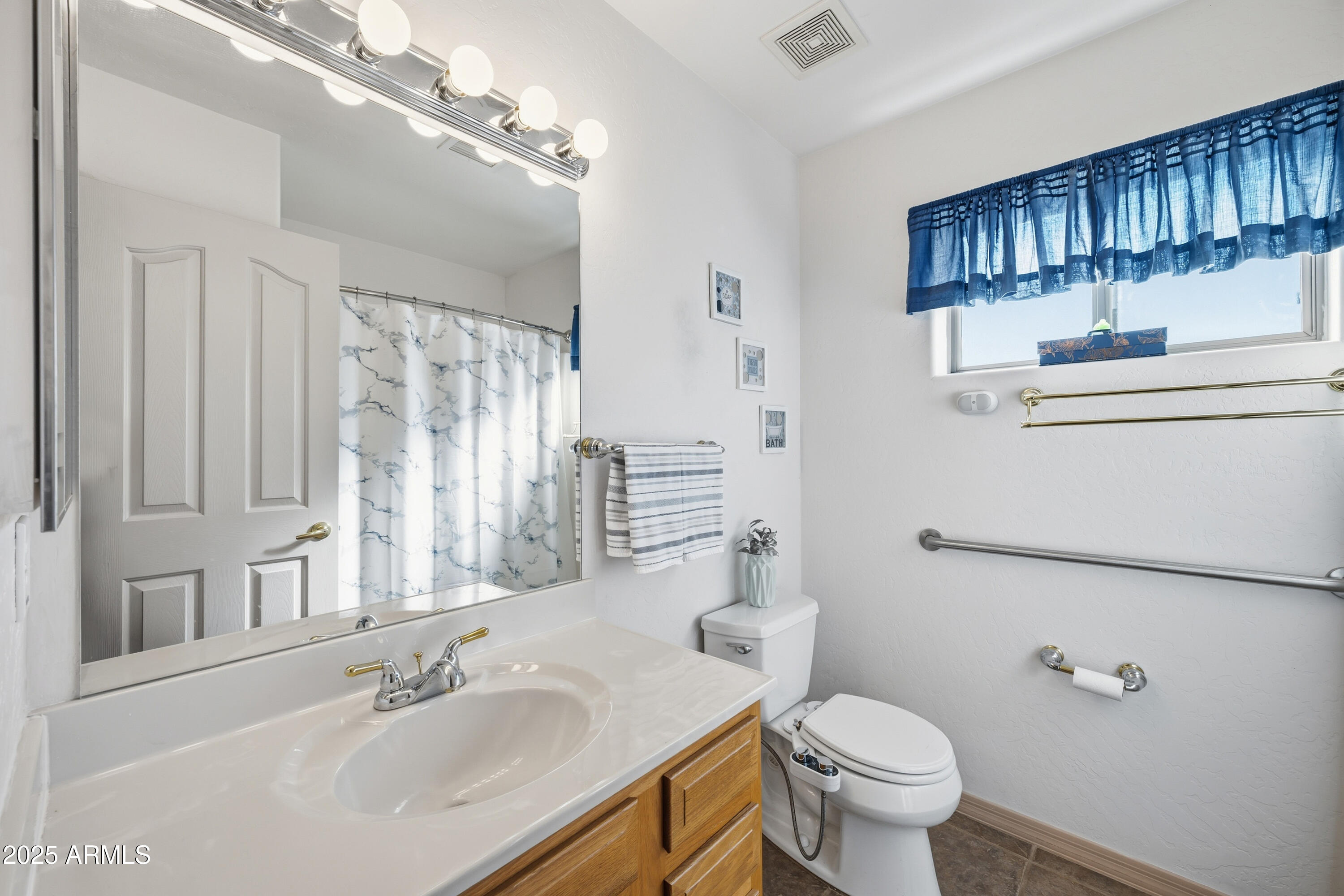 14844 South Brook Hollow Road Arizona City, AZ 85123 - Photo 16 of 35 a bathroom with a sink a toilet and shower