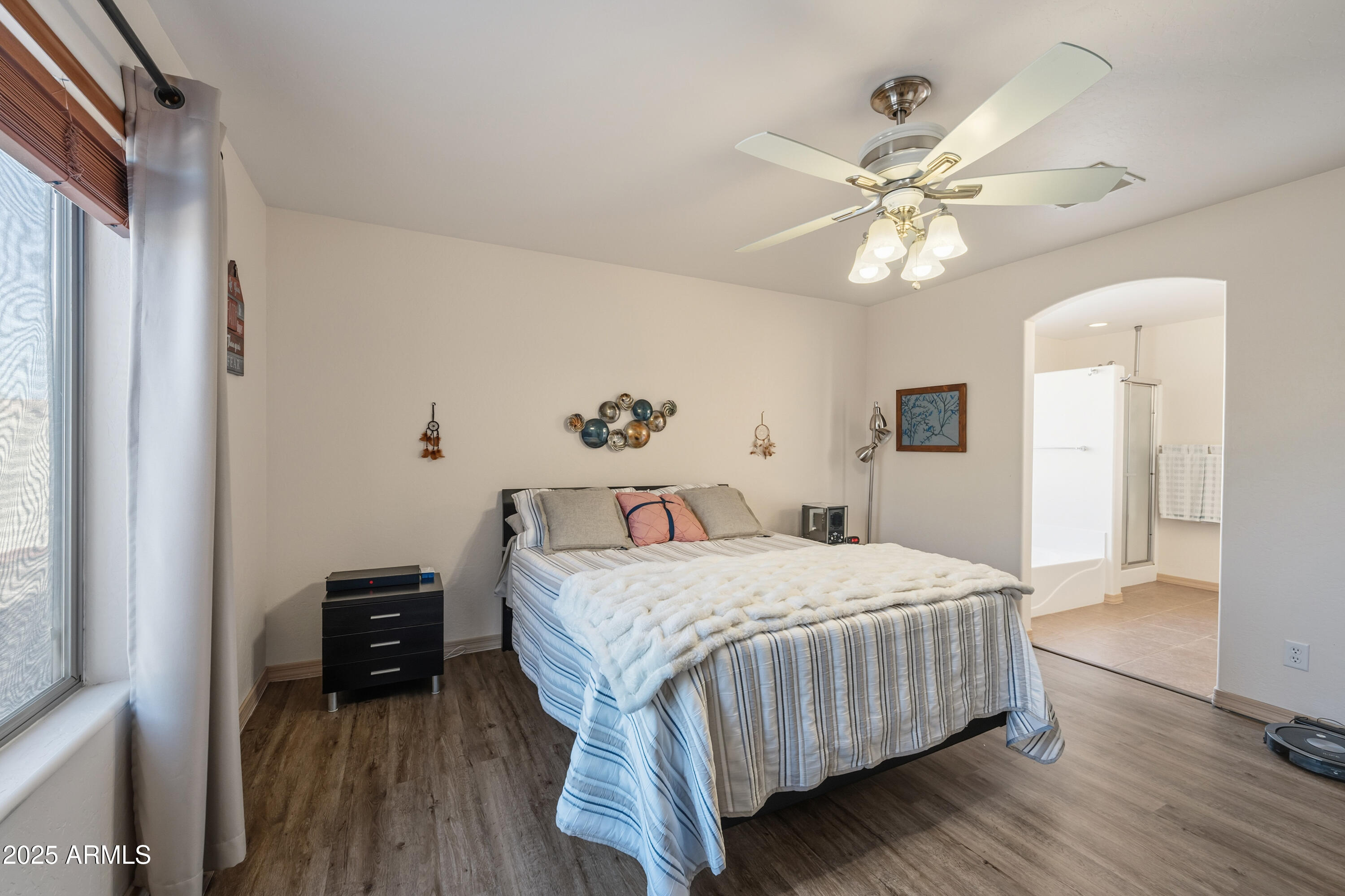 14844 South Brook Hollow Road Arizona City, AZ 85123 - Photo 19 of 35 a bedroom with a bed and a chandelier