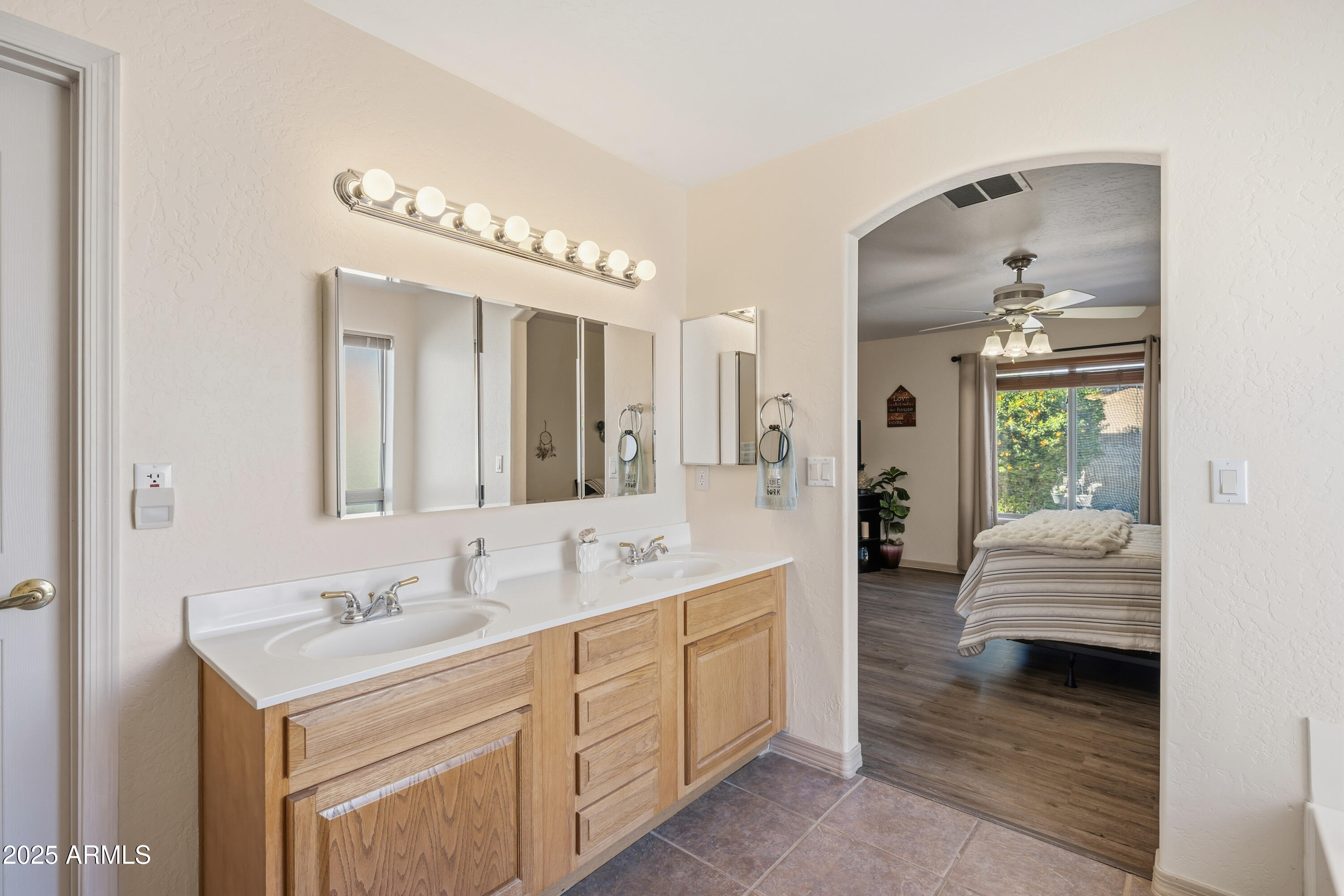 14844 South Brook Hollow Road Arizona City, AZ 85123 - Photo 22 of 35 a spacious bathroom with a double vanity sink and a mirror