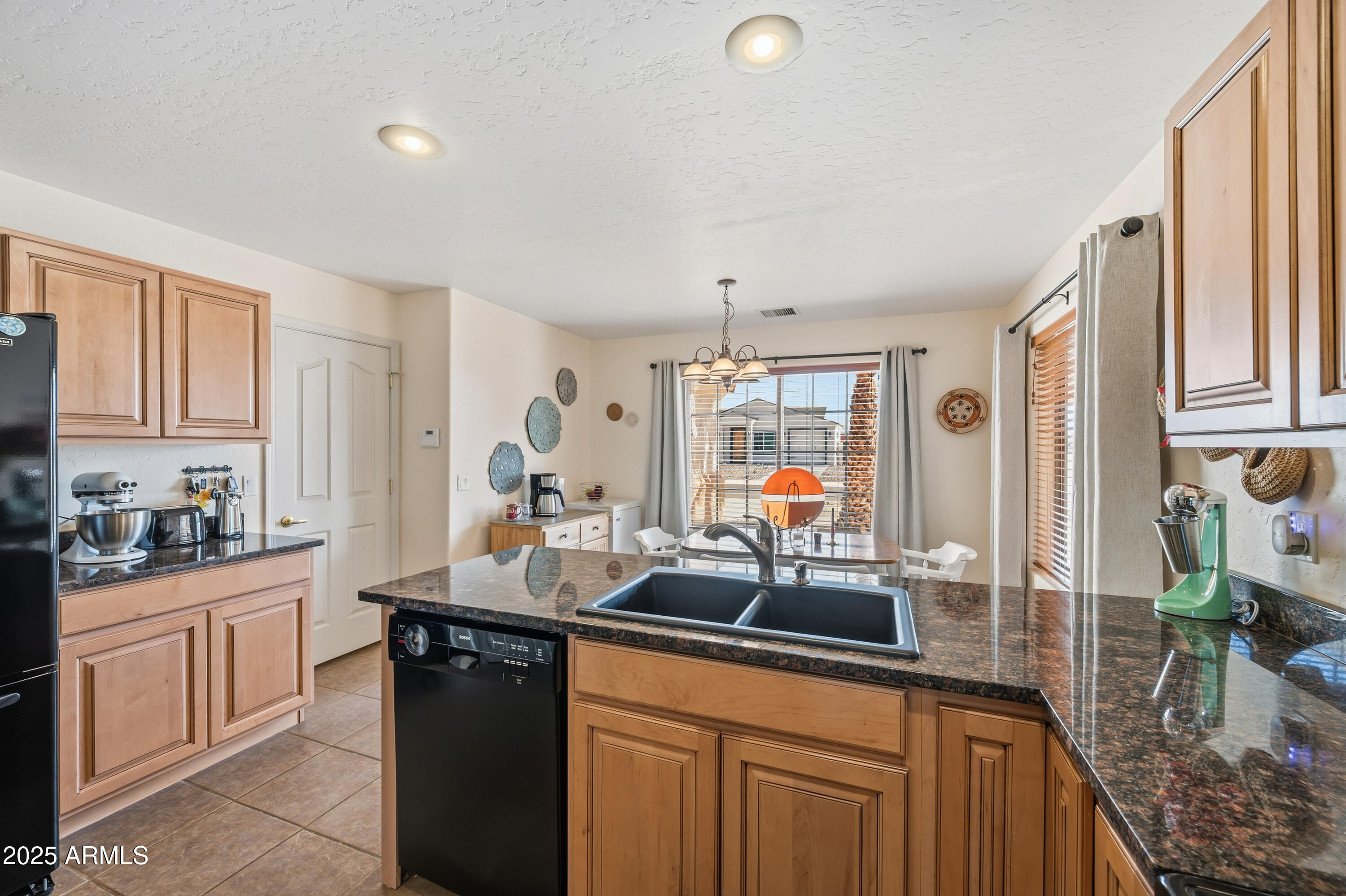 14844 South Brook Hollow Road Arizona City, AZ 85123 - Photo 25 of 35 a kitchen with sink refrigerator and cabinets