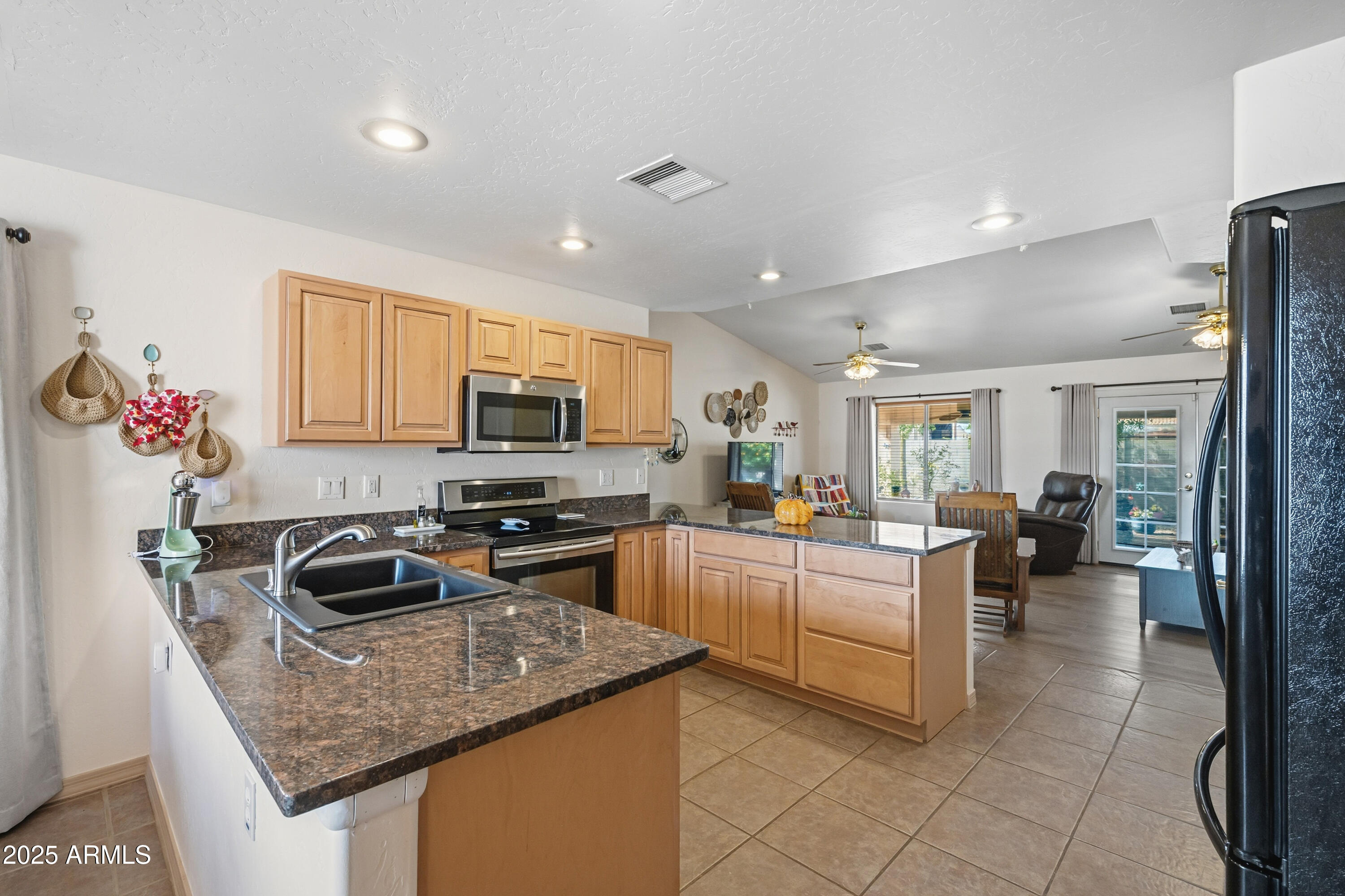14844 South Brook Hollow Road Arizona City, AZ 85123 - Photo 26 of 35 a kitchen with a sink stove and cabinets