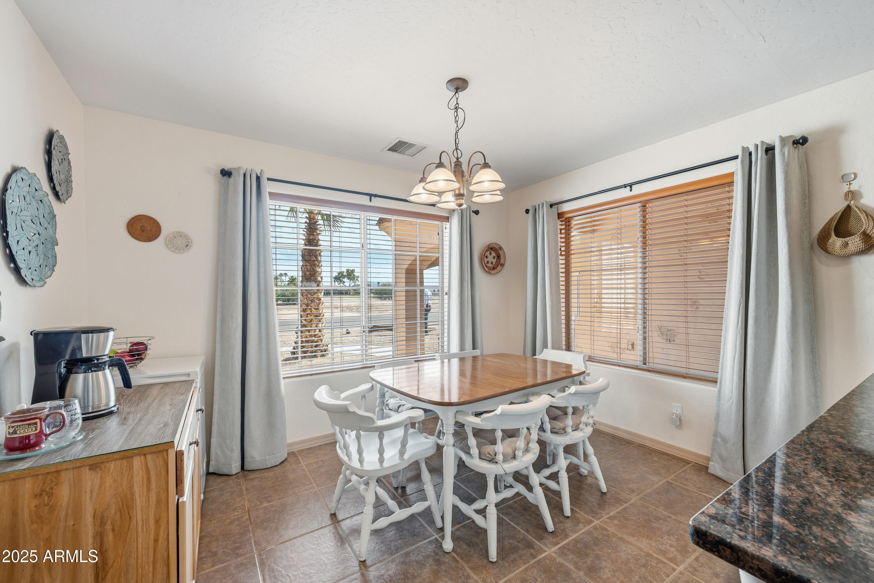 14844 South Brook Hollow Road Arizona City, AZ 85123 - Photo 27 of 35 a dining room with furniture and window