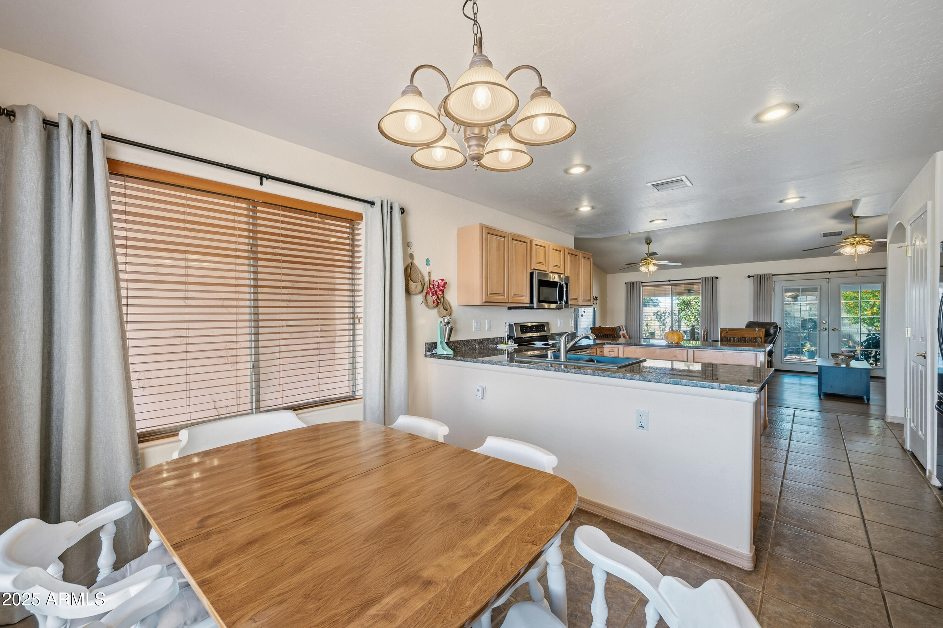 14844 South Brook Hollow Road Arizona City, AZ 85123 - Photo 28 of 35 a open kitchen with a table and chairs in it