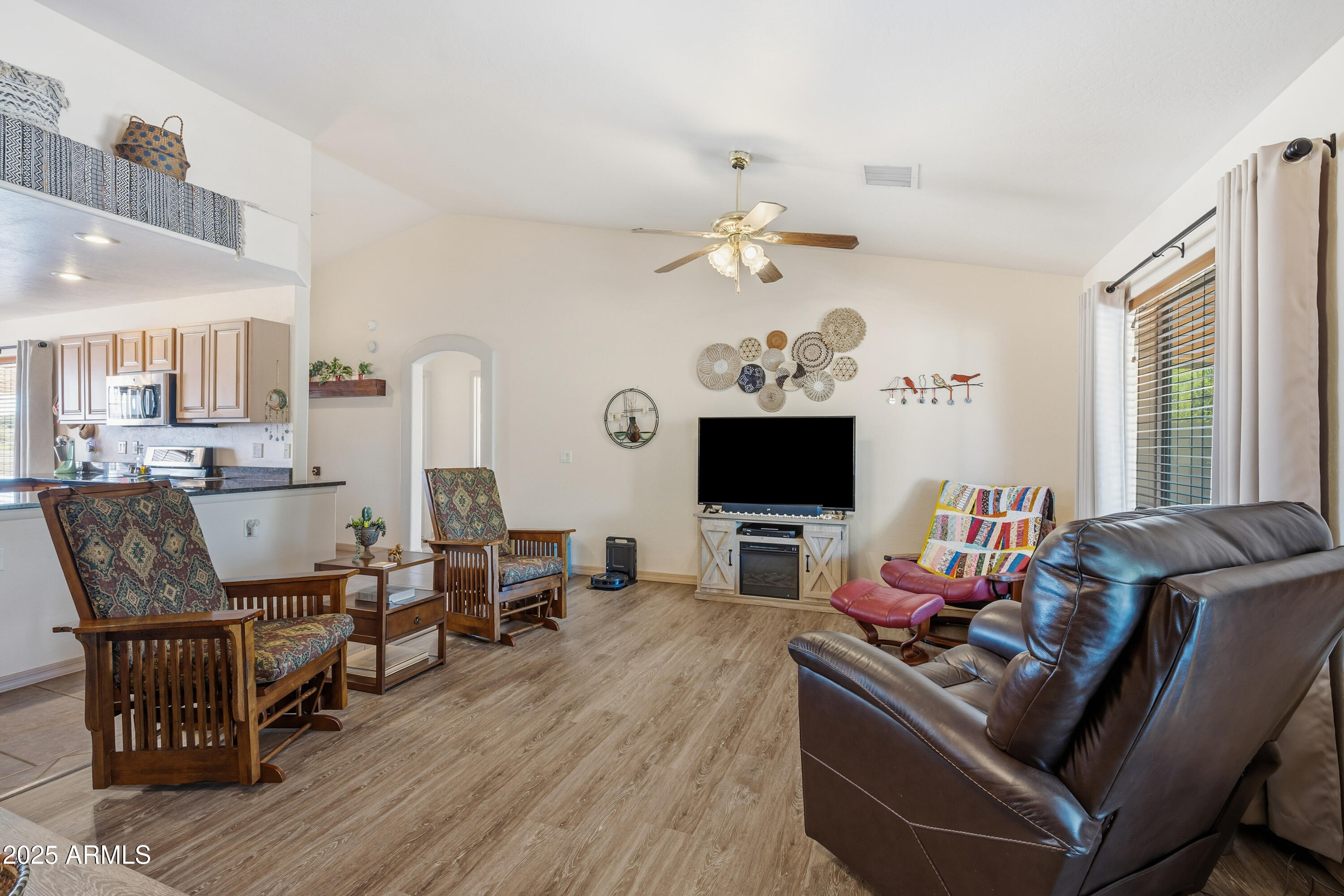 14844 South Brook Hollow Road Arizona City, AZ 85123 - Photo 2 of 35 a living room with furniture kitchen view and a flat screen tv