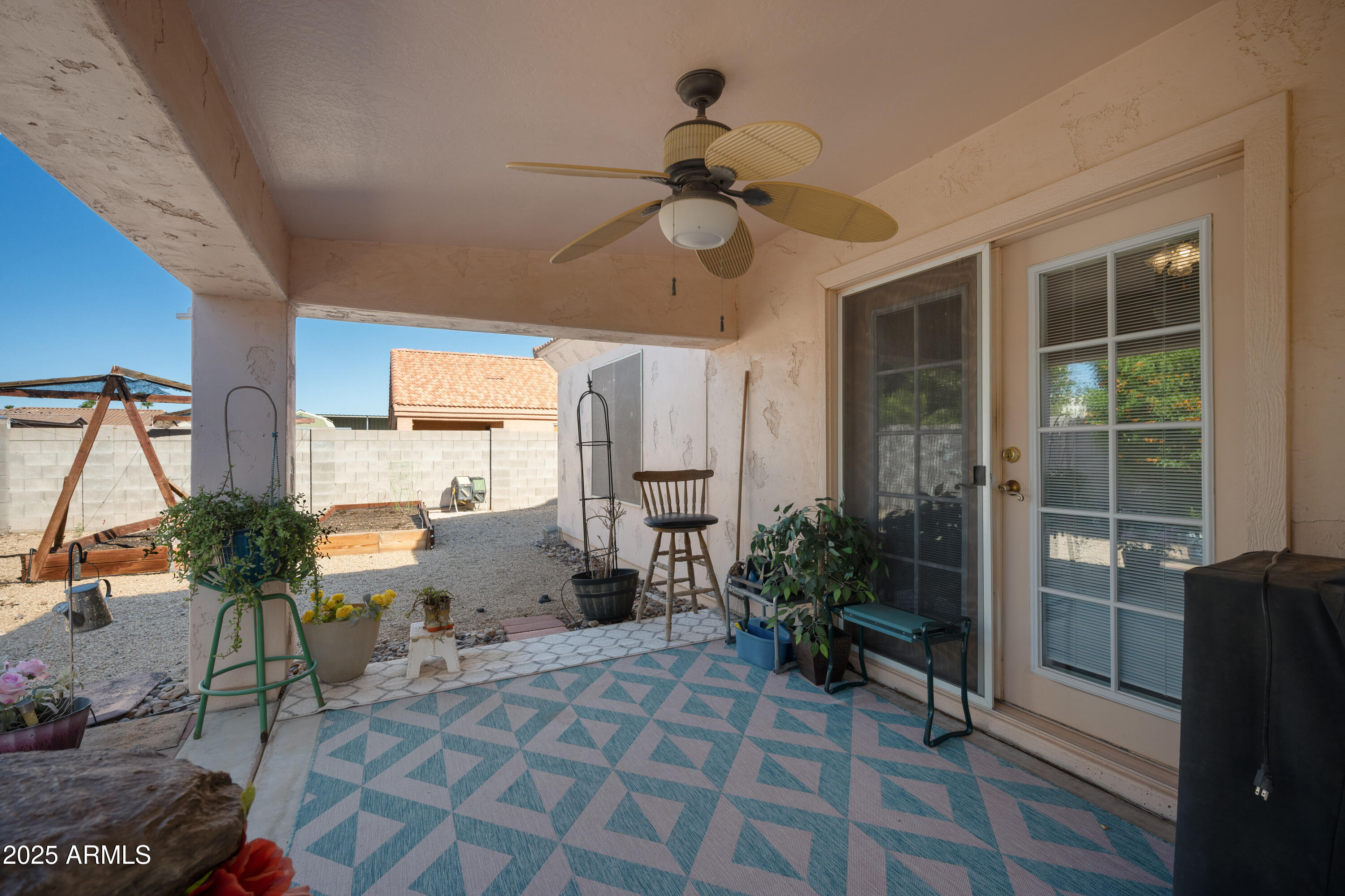 14844 South Brook Hollow Road Arizona City, AZ 85123 - Photo 30 of 35 a living room with furniture a window and a potted plant