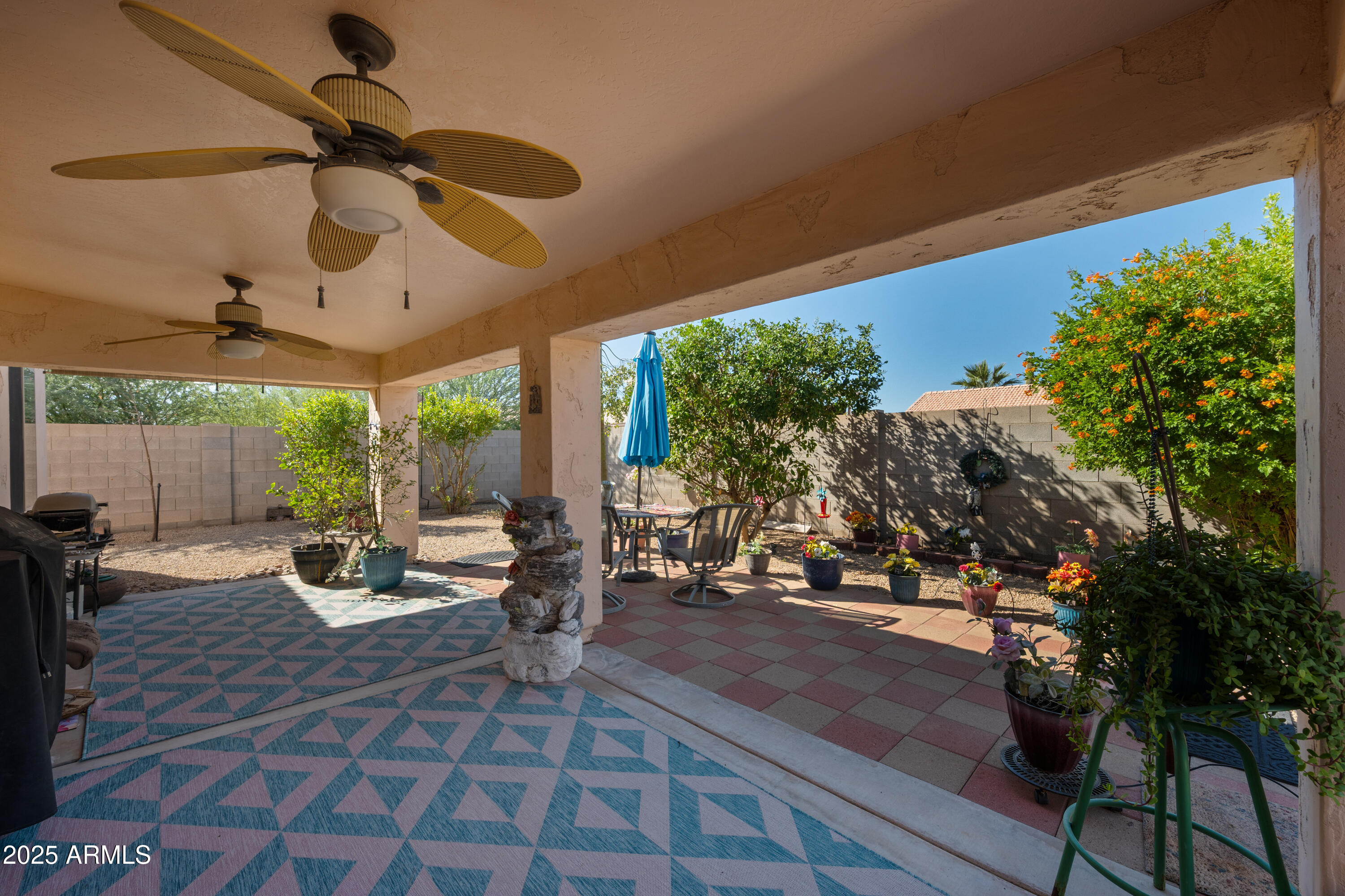 14844 South Brook Hollow Road Arizona City, AZ 85123 - Photo 31 of 35 a view of a patio with table and chairs potted plants with wooden floor