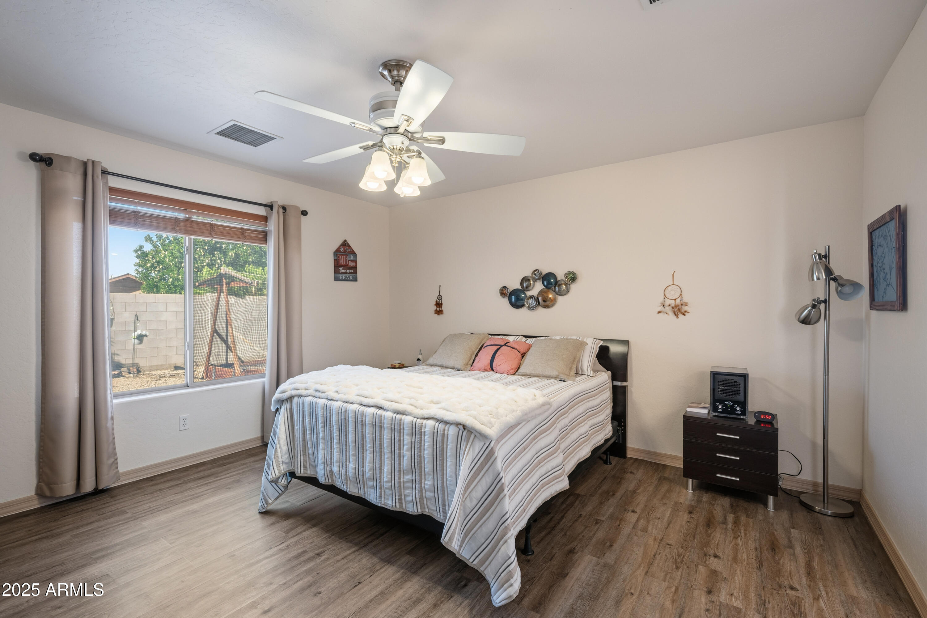 14844 South Brook Hollow Road Arizona City, AZ 85123 - Photo 3 of 35 a bedroom with a bed and wooden floor