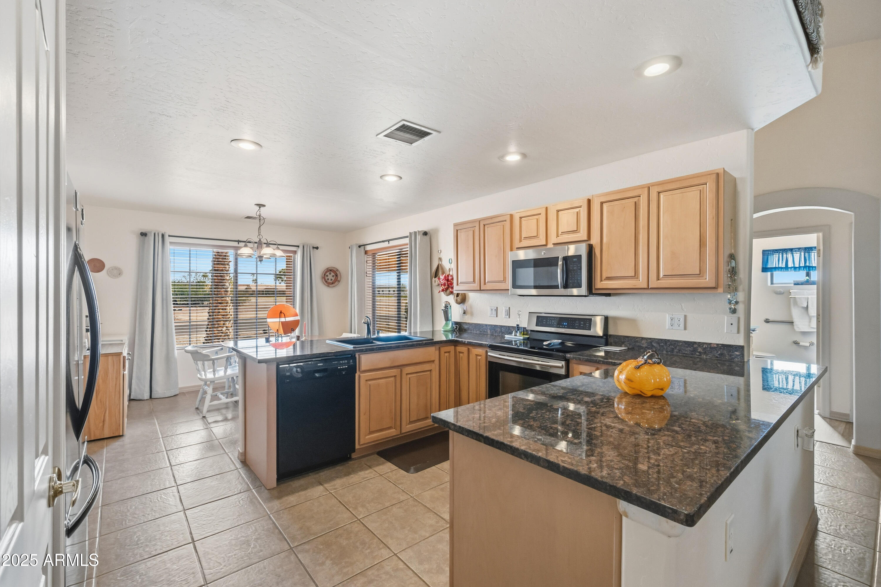 14844 South Brook Hollow Road Arizona City, AZ 85123 - Photo 4 of 35 a kitchen with stainless steel appliances granite countertop a stove sink and cabinets