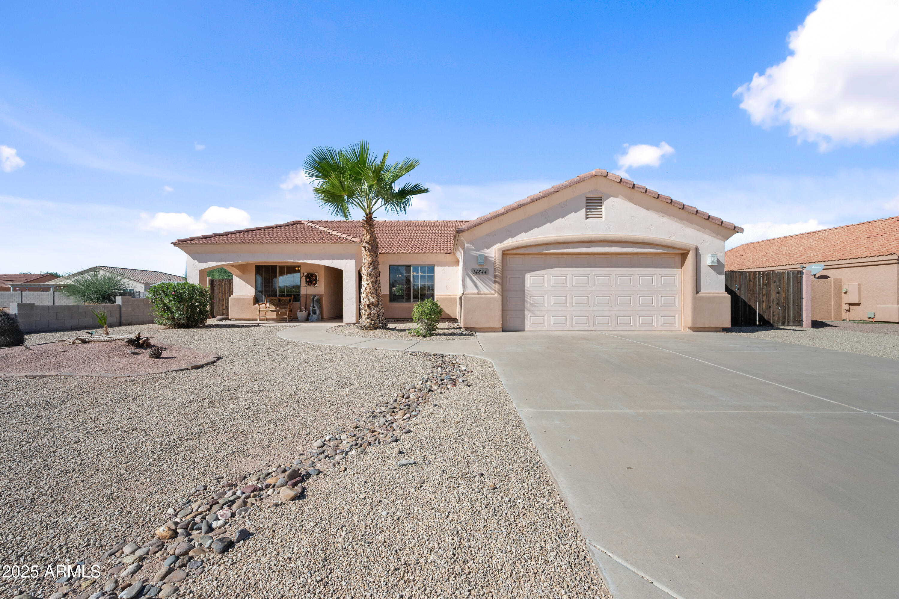 14844 South Brook Hollow Road Arizona City, AZ 85123 - Photo 6 of 35 a front view of a house with a yard and garage