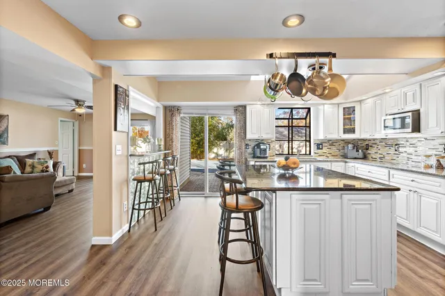 a kitchen with stainless steel appliances granite countertop a stove and cabinets
