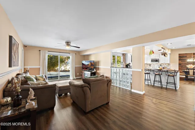 a living room with fireplace furniture and a wooden floor