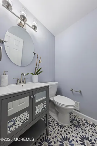 a bathroom with a sink toilet and a mirror