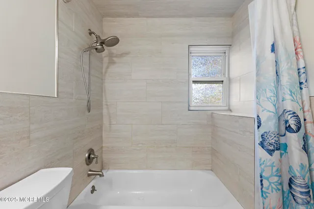 a bathroom with a bathtub and shower
